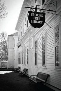 Front of Brooks Free Library with its sign