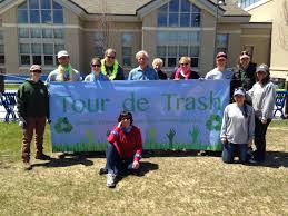 Volunteers for the Tour de Trash cleanup with large banner