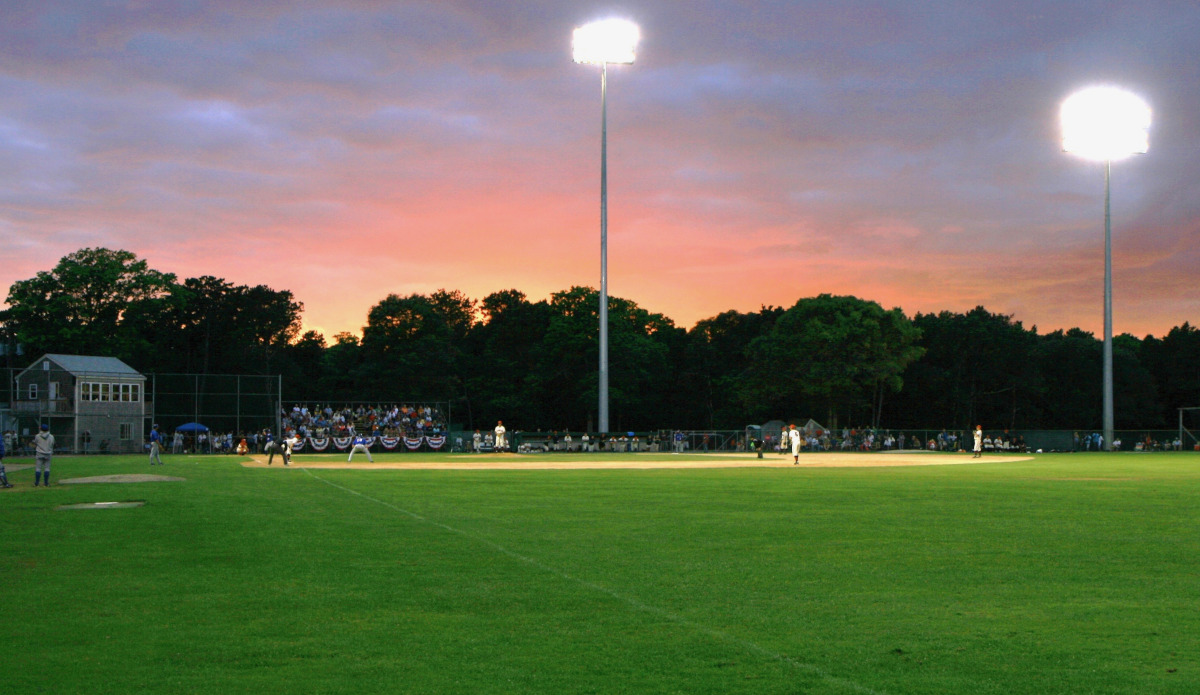 Harwich Mariners baseball game at dusk under field lights